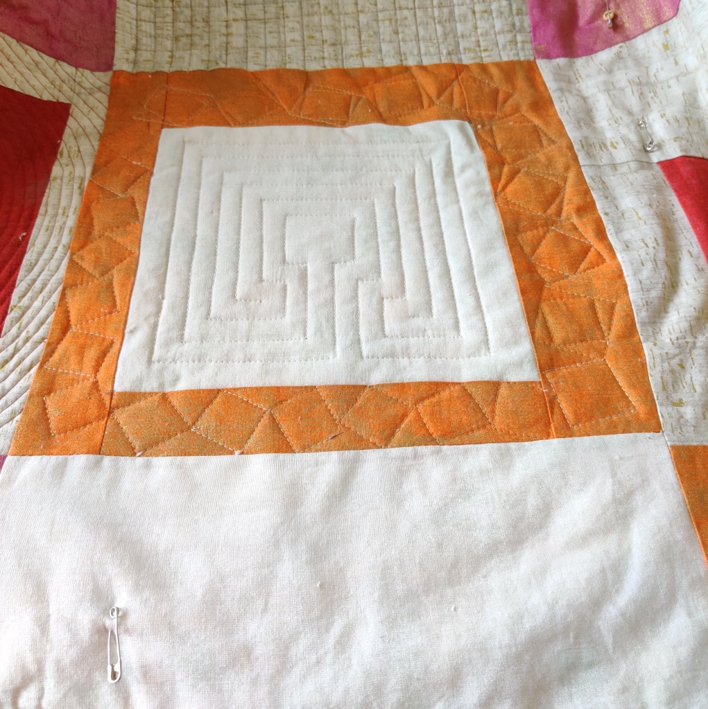 Finished block from design of tumbling Blocks. Quilting done by walking foot
